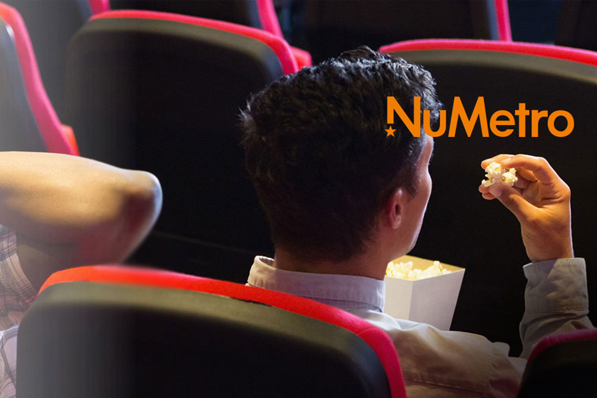 man in a cinema eating popcorn